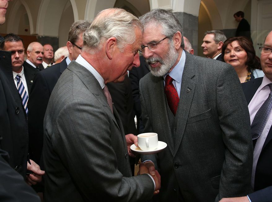 Britain's Prince Charles. left, shakes hands with Sinn Fein president Gerry Adams at the National University of Ireland in Galway, Ireland, Tuesday May 19, 2015. Prince Charles has begun an official visit to Ireland featuring two new milestones of peacemaking: his first meeting with leaders of the Irish nationalist Sinn Fein party, and his first trip to the fishing village where the Irish Republican Army killed his great-uncle 36 years ago. It is Charles’ third trip to the Irish Republic since the outlawed IRA called a 1994 cease-fire. (Brian Lawless/Pool photo via AP)