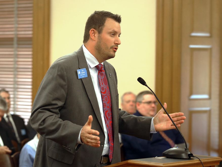 Eric Stafford, with the Kansas Chamber of Commerce, testifies Tuesday, May, 19,2015, in Topeka, Kan., before the House Tax Committee in opposition to a bill that would roll back tax exemptions on business income but maintain tax-free status for income up to $150,000. (Thad Allton/The Topeka Capital-Journal via AP)