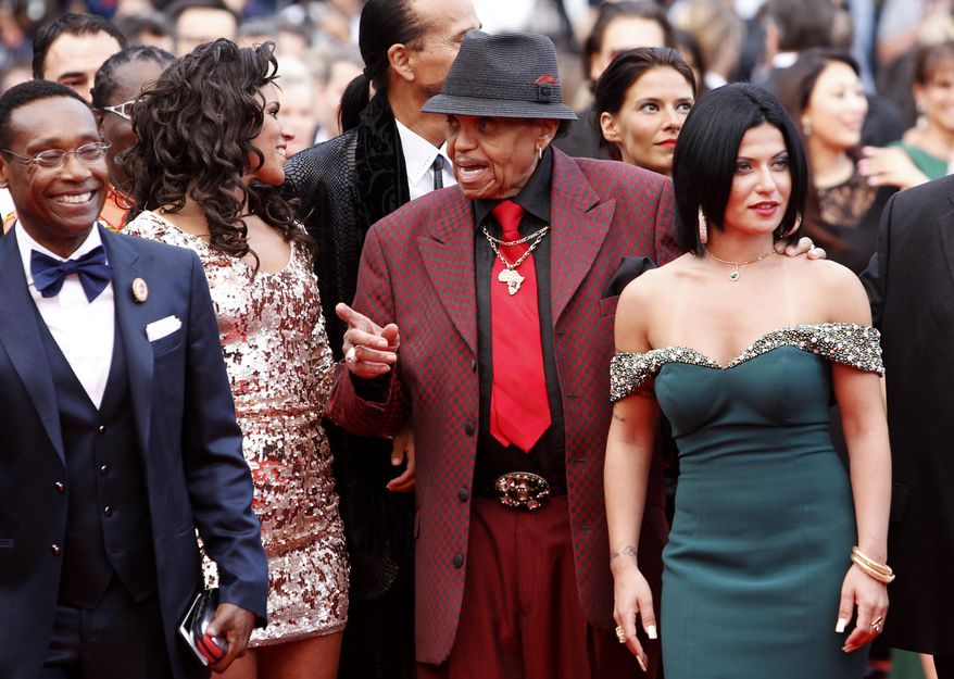 Joe Jackson, center, and unidentified guests arrive for the screening of the film Sicario at the 68th international film festival, Cannes, southern France, Tuesday, May 19, 2015. (AP Photo/Lionel Cironneau)