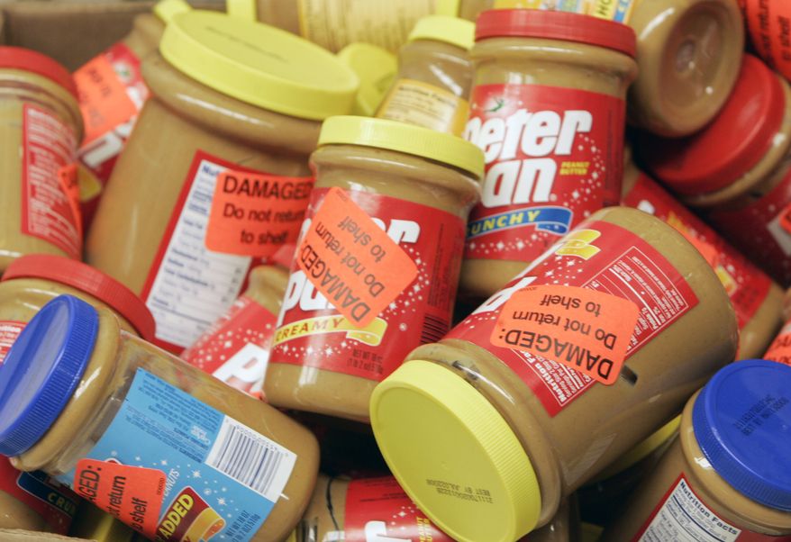 In this Feb. 16, 2007, file photo, returned jars of Peter Pan Peanut Butter are shown at a super market in Atlanta. ConAgra Foods is likely to face a criminal charge now that the U.S. government has completed its investigation of the company&#39;s 2007 peanut butter recall. (AP Photo/John Bazemore, File)