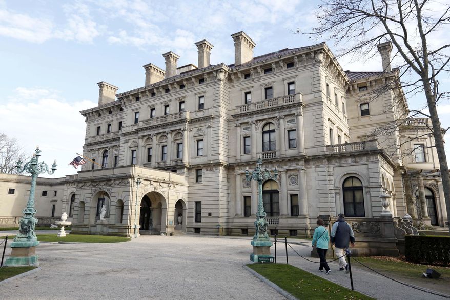 FILE - In this Dec. 1, 2014 file photo, visitors walk toward an entrance to The Breakers mansion in Newport, R.I. Twenty-one members of the Vanderbilt family wrote a letter to the preservation group that owns it, saying its management is no longer fulfilling its commitment to the public trust and is exploiting the family mansion. Donald Ross, board chairman at the Preservation Society of Newport County, said in a May 9, 2015 memo that in the past five years, the signers had contributed only $4,000 total. He also said most of the family members' items displayed at The Breakers are not very significant. (AP Photo/Steven Senne, File)