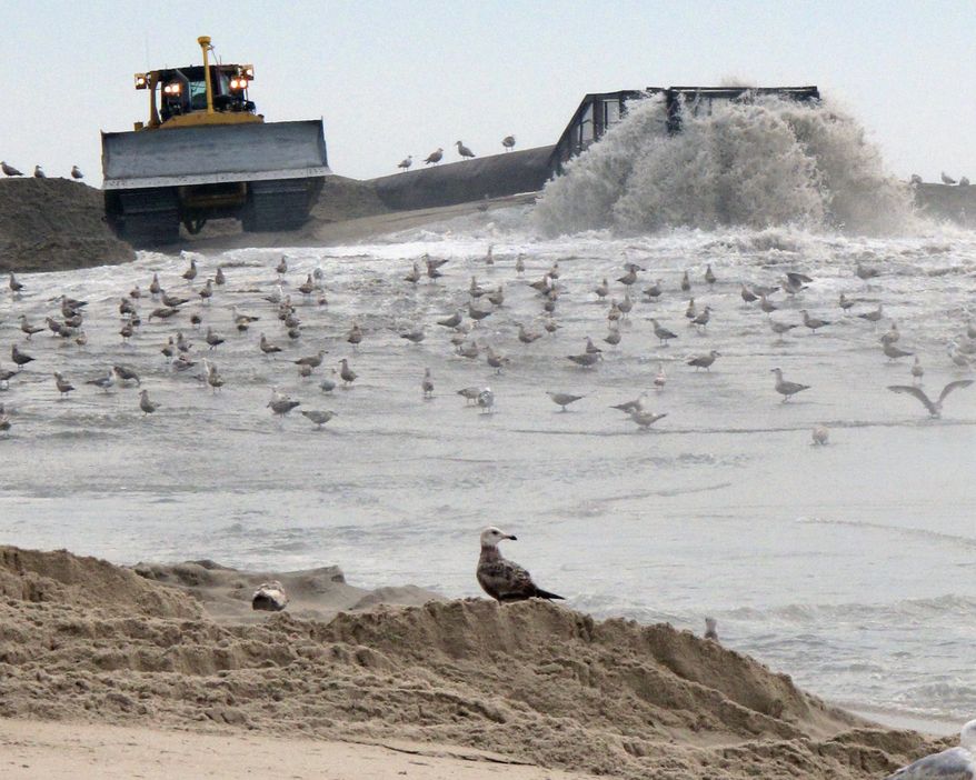 This May 18, 2015 photo shows a mixture of sand and water being pumped ashore in Ship Bottom, N.J. as part of a beach replenishment project being carried out there. Coastal experts say the lack of major winter erosion, and numerous beach widening projects have New Jersey's beaches in excellent shape for the start of the summer season. (AP Photo/Wayne Parry)