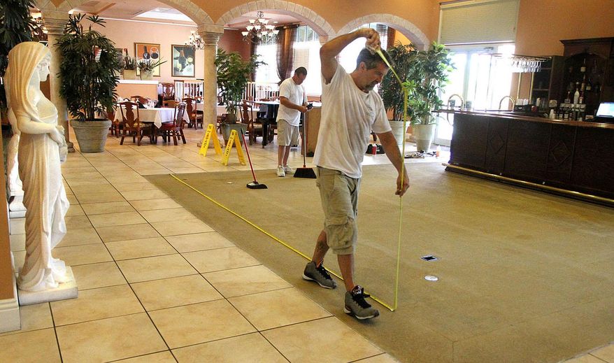 Workers prepare to lay new carpet in the piano bar located in the clubhouse at Caliente Resort & Spa, an internationally known clothing optional resort in Land O' Lakes, Fla., on May 12, 2015. The work at Caliente was being conducted a week after Pasco County officials issued a news release saying the county is on pace to rake in more tourism dollars than it has since 2008, when the economic recession was at its worst. (Andy Jones/The Tampa Tribune via AP) ST. PETERSBURG OUT; LAKELAND OUT; BRADENTON OUT; MAGS OUT; LOCAL TELEVISION OUT; WTSP CH 10 OUT; WFTS CH 28 OUT; WTVT CH 13 OUT; BAYNEWS 9 OUT; THE TAMPA BAY TIMES OUT; LAKELAND LEDGER OUT; BRADENTON HERALD OUT; SARASOTA HERALD-TRIBUNE OUT; WINTER HAVEN NEWS CHIEF OUT