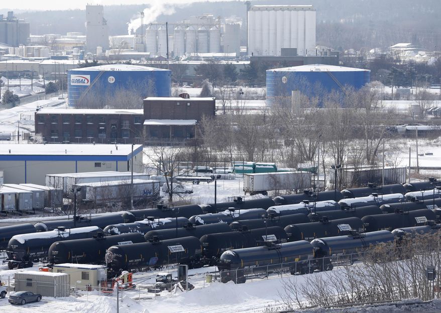 FILE - This Feb. 7, 2014, file photo, shows a view from a nearby apartment building of railroad oil tanker cars at the Port of Albany in Albany, N.Y. New York state regulators are expected to decide soon on a permit for a facility at the Port of Albany that critics say would make the port a hub for heavy Canadian tar sands crude oil as well as the millions of gallons of North Dakota Bakken crude it's now handling. (AP Photo/Mike Groll, File)