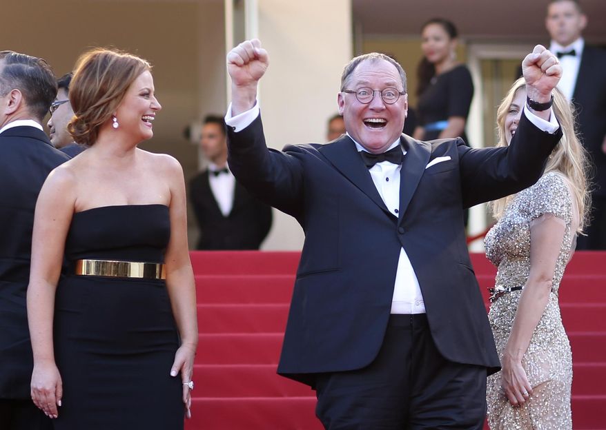Actress Amy Poehler, left, laughs as chief creative officer at Pixar John Lasseter gestures for photographers upon arrival for the screening of the film Inside Out at the 68th international film festival, Cannes, southern France, Monday, May 18, 2015. (AP Photo/Thibault Camus)