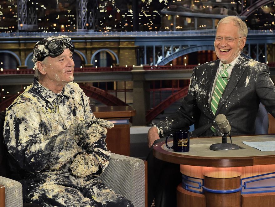 In this photo provided by CBS, actor Bill Murray, left, talks with host David Letterman after emerging from a cake to say good-bye, Tuesday, May 19, 2015, on the set of the “Late Show with David Letterman,” in New York. Letterman’s final show airs Wednesday, May 20. (John Paul Filo/CBS via AP) MANDATORY CREDIT; NO ARCHIVE; NO SALES; NORTH AMERICAN USE ONLY