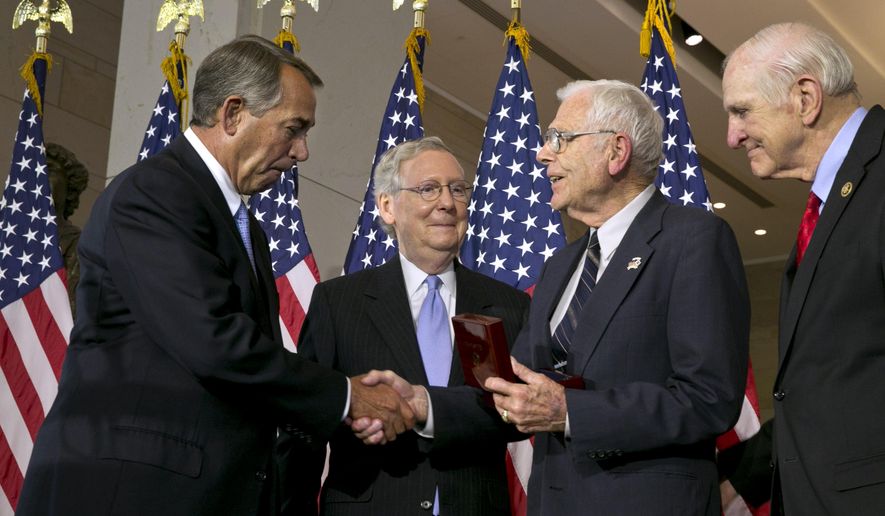 House Speaker John Boehner of Ohio, left, with Senate Majority Leader Mitch McConnell of Ky., second from left, and Rep. Sam Johnson, R-Texas, right, greet retired Air Force Lt. Gen. Charles Cleveland, as they award Cleveland a Congressional Gold Medal on behalf of the American Fighter Aces', Wednesday, May 20, 2015, during a ceremony at Emancipation Hall on Capitol Hill in Washington. (AP Photo/Jacquelyn Martin)