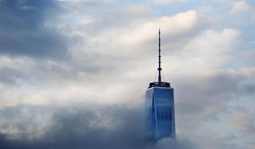 This April 21, 2015, file photo, shows the top floors of New York's One World Trade Center in Lower Manhattan. The observatory atop the 104-story skyscraper is scheduled to open to the public on May 29. (AP Photo/Mark Lennihan, File)