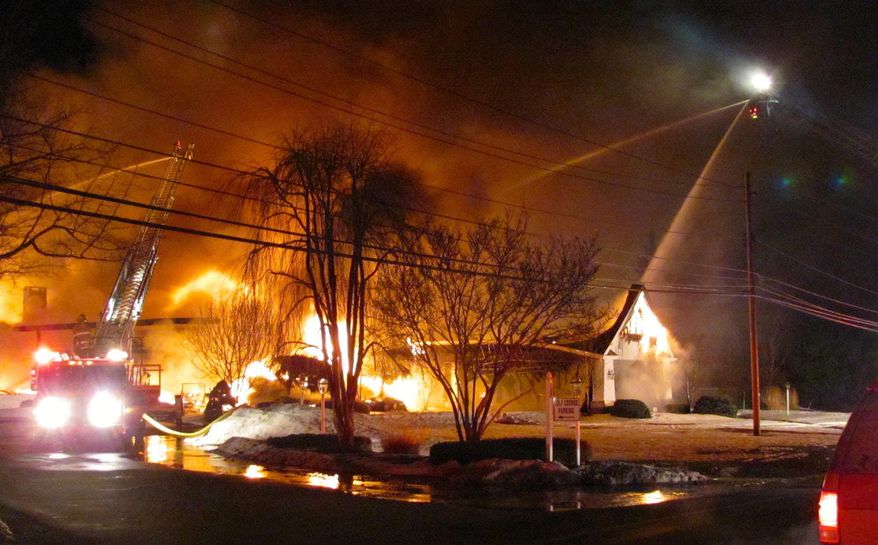 FILE-This Thursday, March 12, 2015 file photo shows firefighters trying to put out a fire at the main clubhouse of the Madison Country Club in Madison, Ohio. Authorities say a man has been arrested on charges alleging he started an early morning fire that destroyed the northeast Ohio country club. Fifty-one-year-old Paul Forner was arrested Monday, May 18 and charged with aggravated arson and disrupting a public service in the March 12 fire that destroyed the Madison County Club in Lake County.(Cliff Pinckard, The Plain Dealer via AP, File) MANDATORY CREDIT; NO SALES