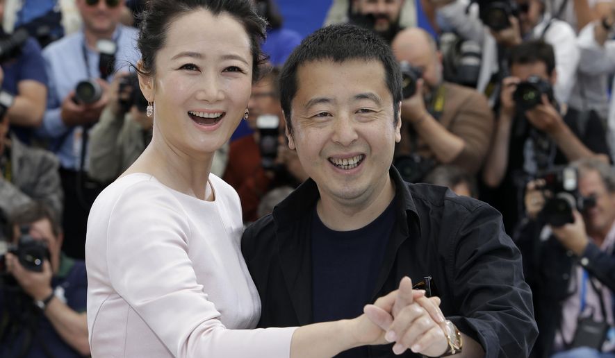 Actress Zhao Tao, left, and director Jia Zhangke pose for photographers during a photo call for the film Shan He Gu Ren (Mountains May Depart), at the 68th international film festival, Cannes, southern France, Wednesday, May 20, 2015. (AP Photo/Lionel Cironneau)