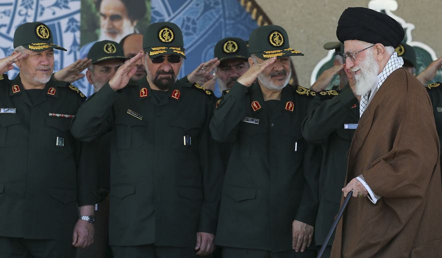 In this picture released by an official website of the office of the Iranian supreme leader on Wednesday, May 20, 2015, Supreme Leader Ayatollah Ali Khamenei, right, arrives at a graduation ceremony of the Revolutionary Guard&#39;s officers, while deputy commander of the Revolutionary Guard, Hossein Salami, second right, former commanders of the Revolutionary Guard Mohsen Rezaei, second left, and Yahya Rahim Safavi salute him in Tehran, Iran. Iran&#39;s supreme leader vowed Wednesday he will not allow international inspection of Iran&#39;s military sites or access to Iranian scientists under any nuclear agreement with world powers. (Office of the Iranian Supreme Leader via AP)