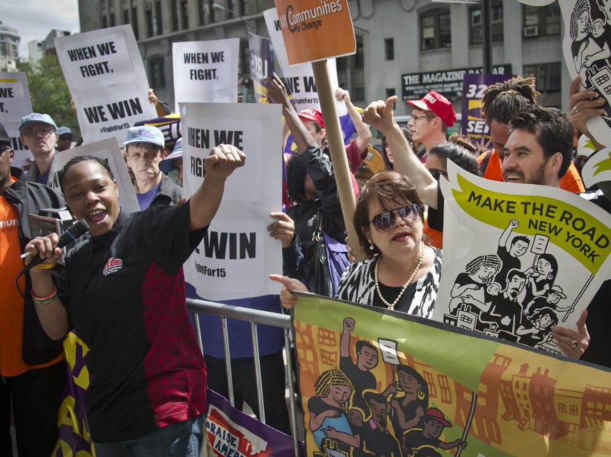 Shantel Walker, 33, left, a worker at Papa John’s Pizza and one of the leaders of the fast food workers movement, speaks during a rally as a state wage board panel prepares to hold its first meeting, Wednesday, May 20, 2015, in New York. The panel, established by Gov. Andrew Cuomo, is considering raising the minimum wage for those in the fast food industry. New York's current minimum wage is $8.75 an hour (AP Photo/Bebeto Matthews)