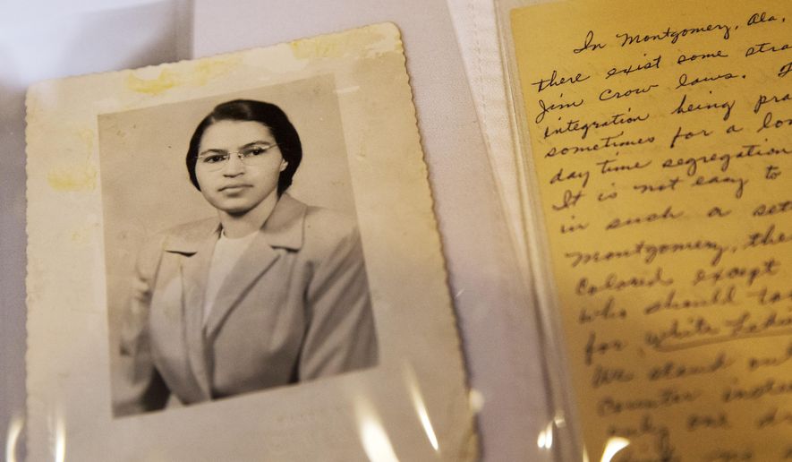FILE - In this Jan. 29, 2015 shows a photograph of Rosa Parks circa the 1950's and a paper written by Parks about segregation are some of the items in the Rosa Parks archive, seen during a media preview at the Library of Congress, Madison Building in Washington. The family of civil rights activist Rosa Parks is thankful her memorabilia and personal items finally have a safe home. The items are on loan to the Library of Congress. They were purchased last year by a charitable foundation run by Howard Buffett, son of billionaire investor Warren Buffett. (AP Photo/Jacquelyn Martin, File)