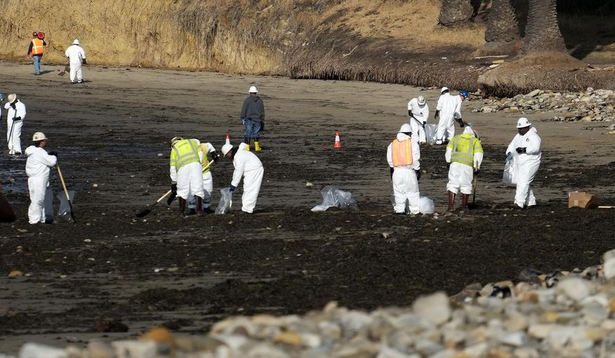 Clean up crews remove oil-laden sand on the beach at Refugio State Beach, site of an oil spill, north of Goleta, Calif., Wednesday, May 20, 2015. A broken onshore pipeline spewed oil down a storm drain and into the ocean for several hours Tuesday before it was shut off, creating a slick some 4 miles long about 20 miles west of Santa Barbara. (AP Photo/Michael A. Mariant)