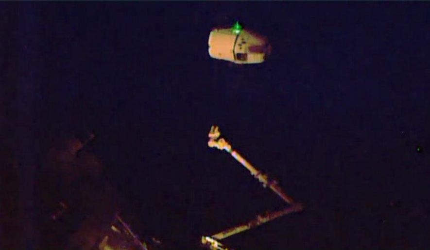 In this photo provided by NASA TV, the SpaceX Dragon is released from the International Space Station on Thursday, May 21, 2015, and begins its departure to Earth. It's headed for an early afternoon splashdown in the Pacific, off the California coast. The capsule arrived at the orbiting lab last month, bearing much-needed groceries and other goods for the six station residents. (NASA TV via AP)
