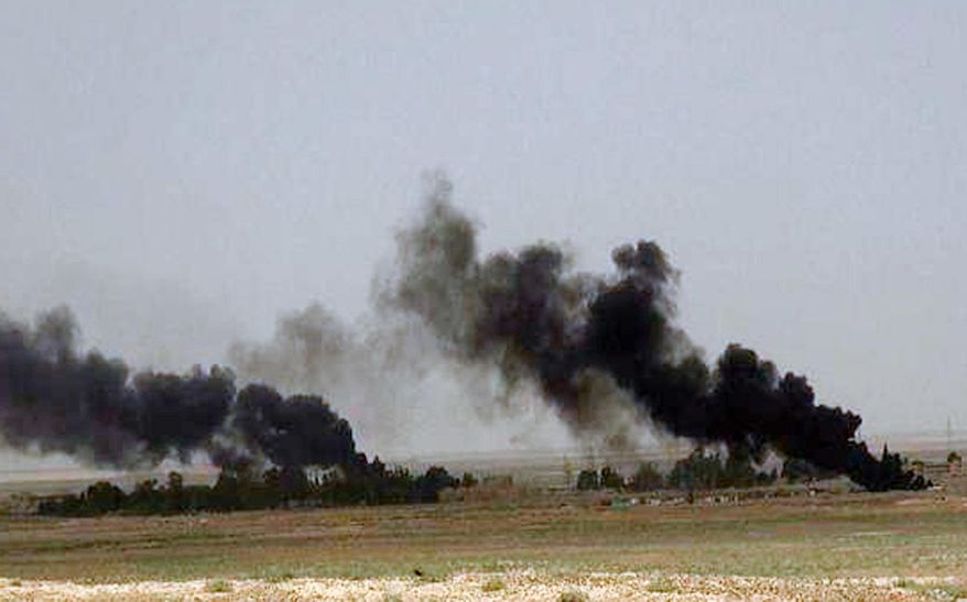 This picture released on Wednesday, May 20, 2015 on the website of Islamic State militants, shows black columns of smoke rising through the air during a battle between Islamic State militants and the Syrian government forces on a road between Homs and Palmyra, Syria. Islamic State militants overran the famed archaeological site at Palmyra early on Thursday, just hours after seizing the central Syrian town, activists and officials said, raising concerns the extremists might destroy some of the priceless ruins as they have done in neighboring Iraq. (The website of Islamic State militants via AP)
