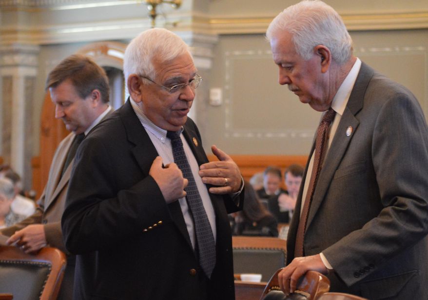 Kansas state Rep. John Rubin, left, R-Shawnee, talks with House Speaker Ray Merrick, R-Stilwell, before the chamber votes on a bill giving the secretary of state the power to prosecute election fraud cases Thursday, May 21, 2015, at the Statehouse in Topeka, Kan. Both said that they support the measure. (AP Photo/Nicholas Clayton)