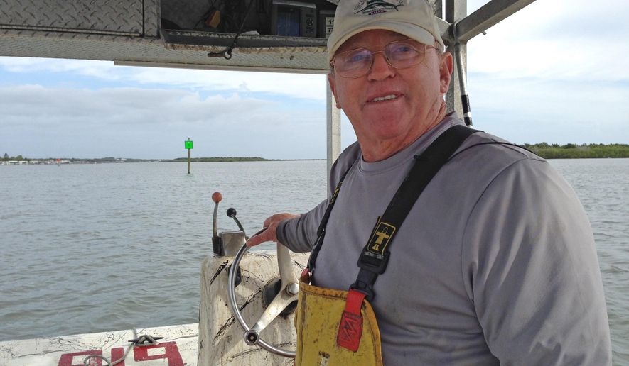 ADVANCE FOR THE WEEKEND OF MAY 23-15 AND THEREAFTER - In a May 5, 2015 photo, George Sweetman cruises the Indian River checking crab traps just south of Oak Hill. Sweetman has been collecting crabs from the Indian River Lagoon for decades. He's opposed to a new law that will prohibit crabbers from renewing their licenses after 2018. (Tim Walters/Florida Today via AP) NO SALES