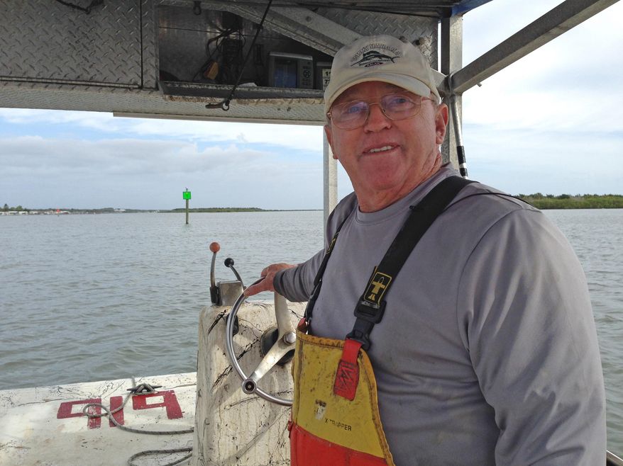 ADVANCE FOR THE WEEKEND OF MAY 23-15 AND THEREAFTER - In a May 5, 2015 photo, George Sweetman cruises the Indian River checking crab traps just south of Oak Hill. Sweetman has been collecting crabs from the Indian River Lagoon for decades. He's opposed to a new law that will prohibit crabbers from renewing their licenses after 2018. (Tim Walters/Florida Today via AP) NO SALES