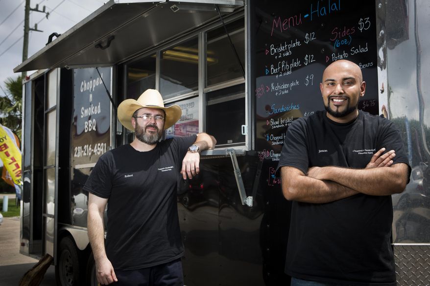 Co-owners Robert West, left, and Jason Bones, right, stand in front of Chopped N Smoked BBQ trailer in Sugar Land, Texas on May 8, 2015. The meat they serve is all Halal which is permissible for consumption according to Islamic law. (Marie D. De Jesus/Houston Chronicle via AP) MANDATORY CREDIT