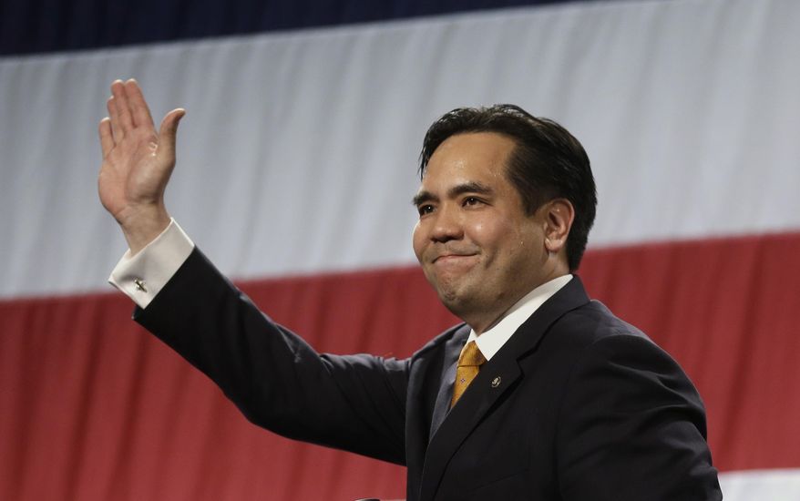 FILE - In this April 25, 2014, file photo, Utah's Attorney General Sean Reyes waves during a rally at the Western Republican Leadership Conference in Sandy, Utah. Reyes accepted a $5,000 campaign donation from a contact lens seller based in the state after his office began defending a new law that critics say was written at the company's behest. Three of the nation's biggest contact lens makers are suing Utah over the law, which bans price-fixing for lenses and could have wide-ranging implications for the industry. They argue it is unconstitutional and was written to benefit discount retailers like 1-800 Contacts. (AP Photo/Rick Bowmer, File)
