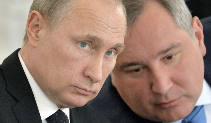 Russian President Vladimir Putin, left, and Deputy Prime Minister Dmitry Rogozin attend a meeting of the Victory Day celebrations organizing committee in the Kremlin in Moscow, Russia, in this March 17, 2015, file photo. (Alexei Druzhinin/RIA Novosti, Kremlin Pool Photo via AP, File)
