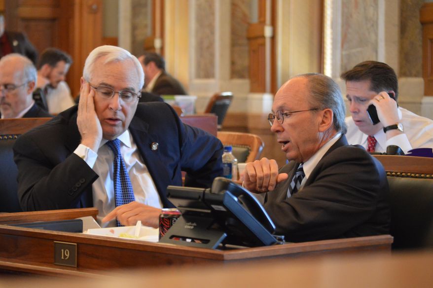 Kansas House Taxation Committee Chairman Marvin Kleeb, R-Overland Park, right, confers with Rep. Jerry Lunn, R-Overland Park, during the chamber's session Thursday, May 21, 2015, at the Statehouse in Topeka, Kan. Lawmakers are struggling to pass a plan for raising taxes to close a budget shortfall. (AP Photo/Nicholas Clayton)