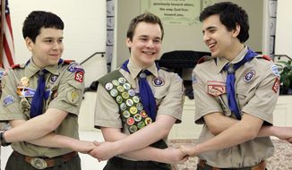 In this Monday, Feb. 10, 2014, file photo, Pascal Tessier, center, takes part in an activity with fellow scouts Matthew Huerta, left, and Michael Fine, right, after he received his Eagle Scout badge in Chevy Chase, Md. On Thursday, April 2, 2015, the Boy Scouts&#39; New York chapter announced it hired Mr. Tessier as the nation&#39;s first openly gay Eagle Scout as a summer camp leader in public contrast to the national scouting organization&#39;s ban on openly gay adult members. (AP Photo/Luis M. Alvarez/File)
