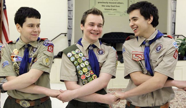 In this Monday, Feb. 10, 2014, file photo, Pascal Tessier, center, takes part in an activity with fellow scouts Matthew Huerta, left, and Michael Fine, right, after he received his Eagle Scout badge in Chevy Chase, Md. On Thursday, April 2, 2015, the Boy Scouts&#x27; New York chapter announced it hired Mr. Tessier as the nation&#x27;s first openly gay Eagle Scout as a summer camp leader in public contrast to the national scouting organization&#x27;s ban on openly gay adult members. (AP Photo/Luis M. Alvarez/File)