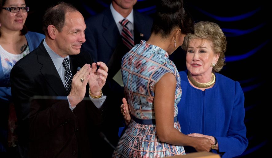 Veterans Affairs Secretary Robert McDonald, first lady Michelle Obama and former Sen. Elizabeth Dole gave a special salute to veterans’ caregivers during a Hidden Heroes Coalition Summit in May 2015. (Associated Press)