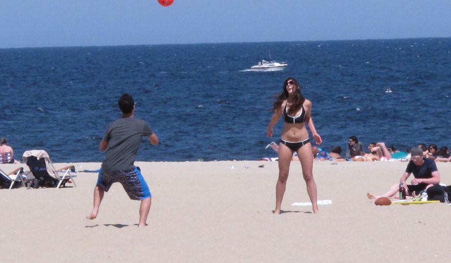 This May 15, 2015 photo, beachgoers play volleyball on the sand in Point Pleasant Beach, N.J. The jersey shore has made substantial progress recovering from Superstorm Sandy 2 1/2 years since the October 2012 storm, but as the third summer after the storm arrives, thousands of homes still have not been repaired. (AP Photo/Wayne Parry)
