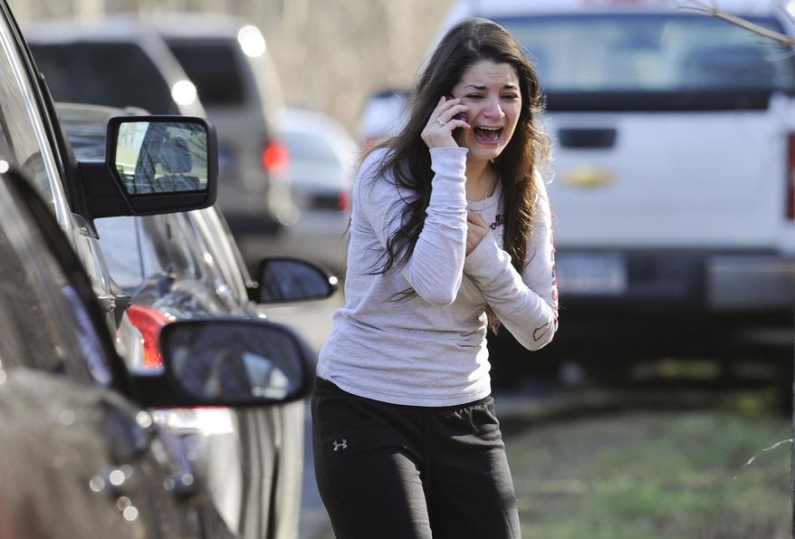FILE - In this Dec. 14, 2012, file photo, Carlee Soto uses a phone to get information about her sister, Victoria Soto, a teacher at the Sandy Hook elementary school in Newtown, Conn., after a gunman killed over two dozen people, including 20 children. Victoria Soto, 27, was among those killed. U.S. public schools beefed up security measures with safety drills and parent notification systems in the years surrounding the massacre at Connecticut's Sandy Hook Elementary School, according to a government survey released Thursday, May 21, 2015. (AP Photo/Jessica Hill, File)