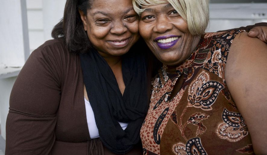 ADVANCED FOR RELEASE SUNDAY, MAY 24, 2015 Antoinette Little, left, and Elaine Green Luke, both survivors of domestic violence who help other women in their community, pose for a photo, May 1, 2015, in Winston-Salem, N.C. (Lauren Carroll/Winston-Salem Journal via AP)