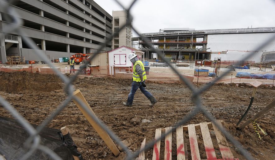 Members of a construction crew work at the site of the new Veterans Administration hospital complex, in Aurora, Colo., Thursday May 21, 2015. The Veterans Affairs Department averted a costly construction shutdown at its half-finished hospital outside Denver on Thursday, but it still has to persuade an angry Congress to come up with hundreds of millions of dollars more to complete the bungled project. (AP Photo/Brennan Linsley)