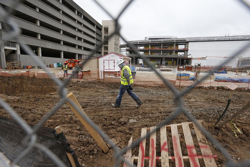Members of a construction crew work at the site of the new Veterans Administration hospital complex, in Aurora, Colo., Thursday May 21, 2015. The Veterans Affairs Department averted a costly construction shutdown at its half-finished hospital outside Denver on Thursday, but it still has to persuade an angry Congress to come up with hundreds of millions of dollars more to complete the bungled project. (AP Photo/Brennan Linsley)