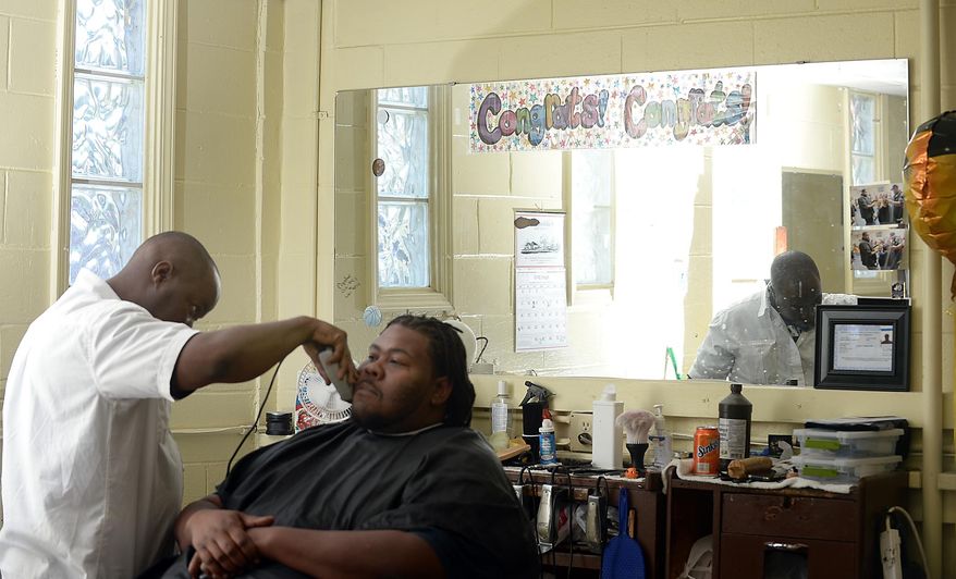 ADVANCE FOR USE TUESDAY, MAY 26 - In this photo taken April 24, 2015, James Proctor talks about his life while giving a haircut at the Southside Barbershop in Spartanburg, S.C. Proctor recently received a license to barber. He apprenticed with Daniel Jones, who has continued a legacy his father began by helping ex-offenders learn a trade that enables them to make a livelihood. (Alex Hicks Jr./The Spartanburg Herald-Journal via AP)