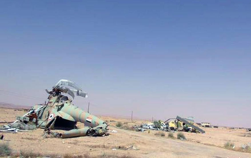 This picture released on Thursday, May 21, 2015 by the website of Islamic State militants, shows damaged Syrian military helicopters at Palmyra air base that was captured by the Islamic State militants after a battle with the Syrian government forces in Palmyra, Syria. Activist and officials say members of the Islamic State group are conducting search operations in the ancient town of Palmyra where they have detained and killed dozens of people. (The website of Islamic State militants via AP)