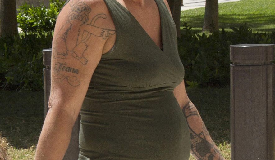 Samantha Leialoha Watanabe walks outside of federal court in Honolulu on Friday, May 22, 2015. Watanabe pleaded not guilty Friday to charges that she physically and verbally assaulted her 15-month-old daughter during an Alaska Airlines flight from Anchorage, Alaska, to Honolulu on May 3, 2015. (Dennis Oda/Honolulu Star-Advertiser via AP)