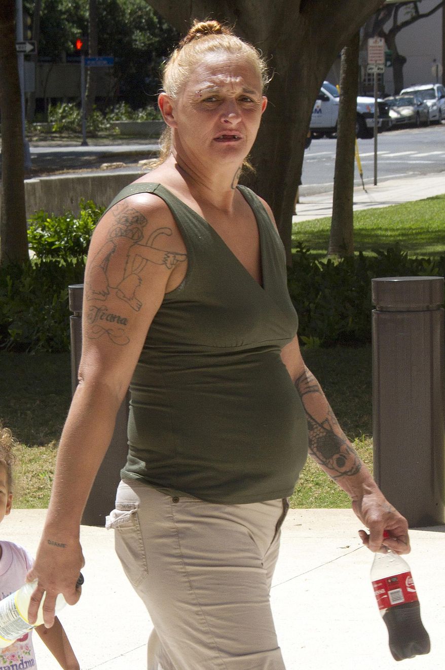 Samantha Leialoha Watanabe walks outside of federal court in Honolulu on Friday, May 22, 2015. Watanabe pleaded not guilty Friday to charges that she physically and verbally assaulted her 15-month-old daughter during an Alaska Airlines flight from Anchorage, Alaska, to Honolulu on May 3, 2015. (Dennis Oda/Honolulu Star-Advertiser via AP)