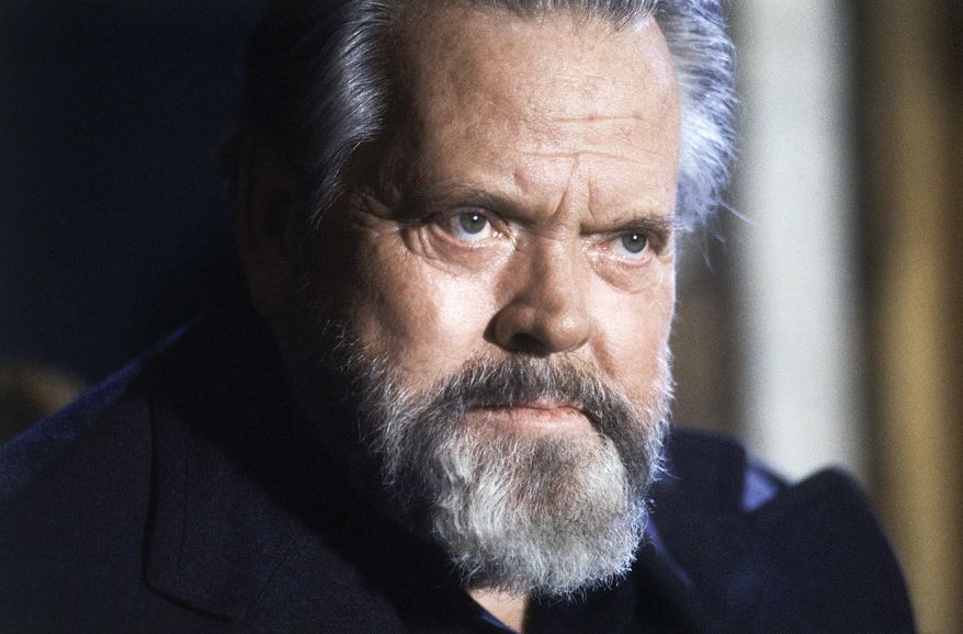 FILE - In this February 22, 1982 file photo, actor and film director Orson Welles poses for photographers during a press conference in Paris. A “very raw draft” of an unpublished Orson Welles memoir has joined the University of Michigan archives on the trailblazing filmmaker, the school says. (AP Photo/Jacques Langevin, File)