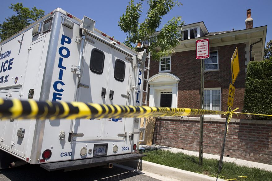 Police work the scene of a fire-damaged multimillion-dollar home in northwest Washington home, Friday May 22, 2015, where 46-year-old Savvas Savopoulos, his 47-year-old wife, Amy Savopoulos, the couple's 10-year-old son Philip, and housekeeper Veralicia Figueroa were found dead May 14. U.S. marshals and police arrested a dangerous ex-convict and took his five companions into custody, safely ending a multistate manhunt in the slayings of a wealthy Washington family and their housekeeper. The fugitive task force tracked Daron Dylon Wint to New York and back before they caught up with him late Thursday (AP Photo/Jacquelyn Martin)