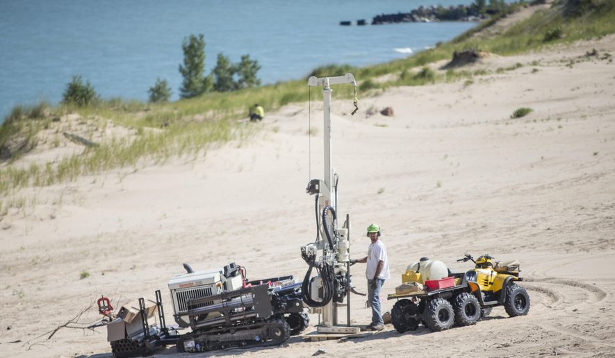 FILE - In this Aug. 14, 2014 file photo, a researcher uses large equipment to study Indiana Dunes National Lakeshore&#39;s Mount Baldy in Michigan City, Ind. The popular sand dune at the Indiana Dunes National Lakeshore along Lake Michigan will remain closed this summer as scientists study what caused a boy to nearly be buried alive in 2013, a park spokesman said Friday May, 22, 2015.  (AP Photo/South Bend Tribune, Robert Franklin, File)