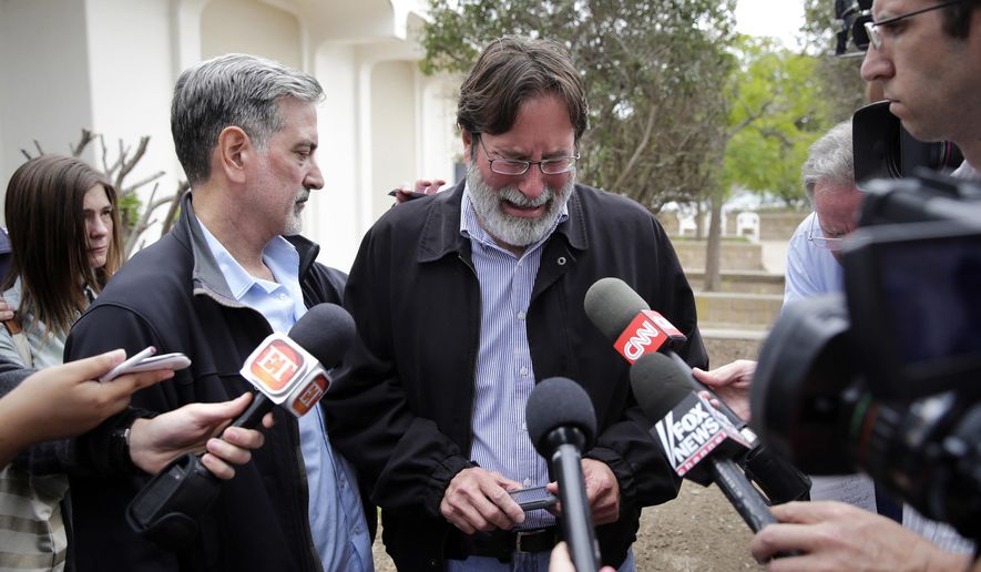 FILE - In this May 24, 2014, file photo, Richard Martinez, center, who said his son Christopher Martinez was killed in a mass shooting that took place in Isla Vista, Calif., is comforted by his brother Alan as he talks to media outside the Santa Barbara County Sheriff's Headquarters in Santa Barbara, Calif. Martinez thinks of his son every day, says, and with those thoughts come the constant reminder of a young life cut tragically short by one of the nation's worst school killings. (AP Photo/Jae C. Hong, File)