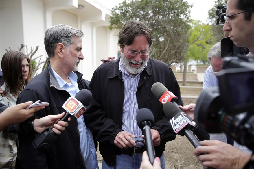 FILE - In this May 24, 2014, file photo, Richard Martinez, center, who said his son Christopher Martinez was killed in a mass shooting that took place in Isla Vista, Calif., is comforted by his brother Alan as he talks to media outside the Santa Barbara County Sheriff's Headquarters in Santa Barbara, Calif. Martinez thinks of his son every day, says, and with those thoughts come the constant reminder of a young life cut tragically short by one of the nation's worst school killings. (AP Photo/Jae C. Hong, File)