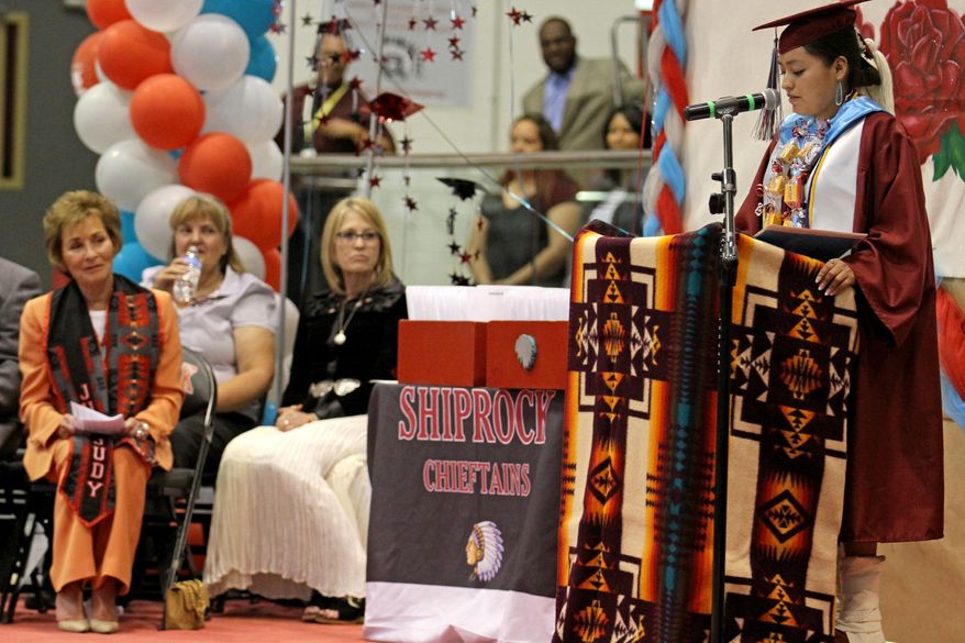 In this photo taken Thursday, May 21, 2015,  graduate Alexus Uentillie, right, guest speaker Judge Judith Sheindlin, left, at the Shiprock High School graduation ceremony at the Chieftain Pit in Shiprock, N.M. The woman known has &#39;Judge Judy&#39; has shared life lessons with Shiprock High School grads. (Alexa Rogals/The Daily Times via AP)