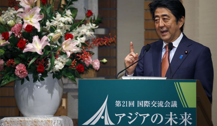 Japanese Prime Minister Shinzo Abe speaks during a banquet of a symposium on the "Future of Asia" in Tokyo, Thursday, May 21, 2015. Vying to keep pace with China's rising influence and economic clout, Japan plans to provide $110 billion to help develop roads, ports and other infrastructure in Asia in the next five years, Prime Minister Abe said Thursday. (AP Photo/Shizuo Kambayashi)