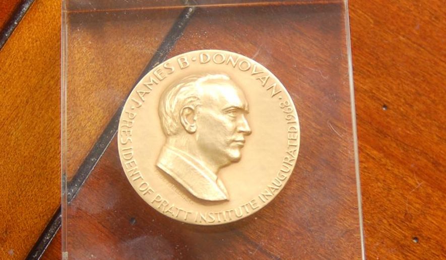 ADVANCE FOR RELEASE MONDAY, MAY 25, 2015, AND THEREAFTER- This April 20, 2015 photo shows James B. Donovan's award that he received when he he became president of the Pratt Institute in New York City and two buttons from his campaign as the Democratic nominee for U.S. Senate in 1962 in Alcolu, S.C. Donovan in 1962 arranged for the release of Francis Gary Powers, an American pilot who was shot down while on a reconnaissance mission over Soviet Union. Tom Hanks is playing Donovan in the lead of "Bridge of Spies" a Hollywood movie directed by Steven Spielberg. (Konstantin Vengerowsky/The Item via AP)
