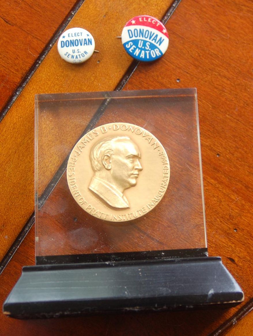 ADVANCE FOR RELEASE MONDAY, MAY 25, 2015, AND THEREAFTER- This April 20, 2015 photo shows James B. Donovan's award that he received when he he became president of the Pratt Institute in New York City and two buttons from his campaign as the Democratic nominee for U.S. Senate in 1962 in Alcolu, S.C. Donovan in 1962 arranged for the release of Francis Gary Powers, an American pilot who was shot down while on a reconnaissance mission over Soviet Union. Tom Hanks is playing Donovan in the lead of "Bridge of Spies" a Hollywood movie directed by Steven Spielberg. (Konstantin Vengerowsky/The Item via AP)