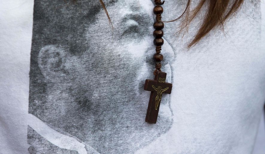 FILE - In this Friday, Jan. 23, 2015, file photo, San Cristobal&#39;s Mayor Patricia Gutierrez wears a rosary and a T-shirt with an image of her jailed husband Daniel Ceballos with a hashtag that reads in Spanish &amp;quot;Free Ceballos&amp;quot; at a protest in San Cristobal, Venezuela. Ceballos phoned his mother before dawn on Saturday, May 23, 2015 to say he&#39;d been moved to a prison in San Juan de los Morros, according to his attorney. (AP Photo/Fernando Llano, File)
