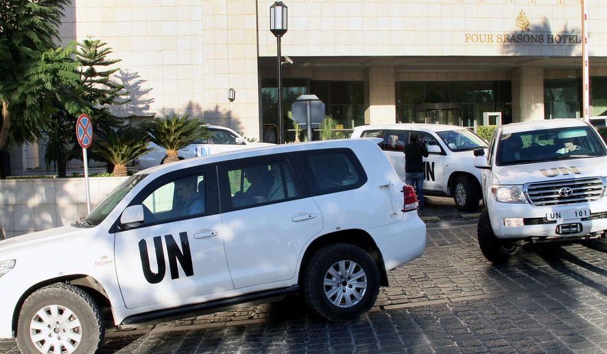 FILE - In this Oct. 8, 2013 file photo, a convoy of chemical weapons disarmament experts depart the Four Seasons Hotel in Damascus, Syria. Two years after President Bashar Assad agreed to destroy his chemical arsenal and joined the Chemical Weapons Convention, activists said they have documented 18 cases of chlorine gas used in the country's rebel-held north since March 6, 2015, when the U.N. issued a resolution determining that chlorine was used in Syria and warning of repercussions. (AP Photo, File)